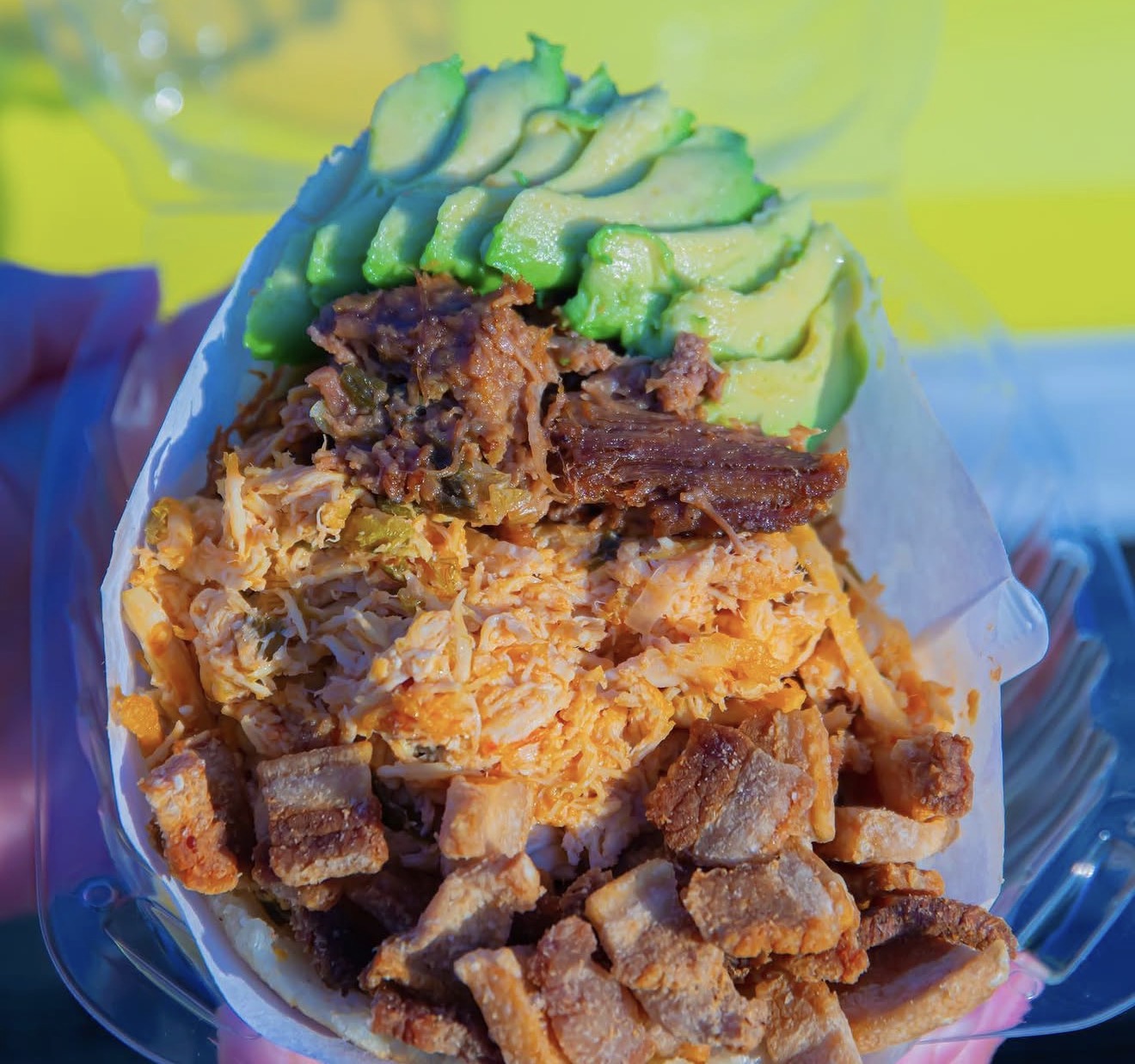 Arepa bowl loaded with shredded meat and fresh avocado